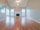 Spacious living room with vaulted ceiling, fireplace, wood floors, and plenty of natural light at 334 Royal Crescent Way, Stockbridge, GA 30281