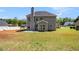 Spacious backyard featuring a lush lawn, gray siding and mature trees at 45 Chapman Way, Covington, GA 30016