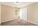 Comfortable bedroom features carpet floor, neutral walls, and a double door closet at 45 Chapman Way, Covington, GA 30016