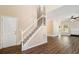 Inviting entryway features hardwood floors, a staircase with white railing, and views into the living spaces at 45 Chapman Way, Covington, GA 30016