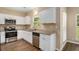 Well-equipped kitchen with stainless steel appliances, granite countertops, and white cabinets at 45 Chapman Way, Covington, GA 30016