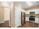 Modern kitchen with stainless steel appliances, granite countertops, white cabinets, and hardwood floors at 45 Chapman Way, Covington, GA 30016
