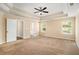 Expansive primary bedroom with tray ceilings, a ceiling fan, and plenty of natural light at 45 Chapman Way, Covington, GA 30016