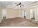 Spacious primary bedroom featuring tray ceilings, neutral walls, and multiple doorways at 45 Chapman Way, Covington, GA 30016