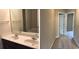Bright bathroom featuring double sinks, a large mirror and a separate bathtub at 6158 Thorncrest Dr, Tucker, GA 30084