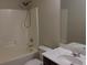 Bathroom with shower-tub, single sink vanity with large mirror, and standard toilet at 6158 Thorncrest Dr, Tucker, GA 30084