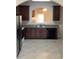 A kitchen with granite countertops, stainless steel appliances, and dark cabinets, ready for cooking experiences at 6158 Thorncrest Dr, Tucker, GA 30084