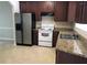 Functional kitchen with stainless steel refrigerator and white oven, complemented by granite countertops at 6158 Thorncrest Dr, Tucker, GA 30084