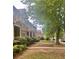 A quiet street view shows neatly kept townhomes with beautiful greenery and sidewalks at 6158 Thorncrest Dr, Tucker, GA 30084