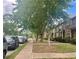 Neighborhood street view with neatly kept lawns, sidewalks and parked cars, perfect for families at 6158 Thorncrest Dr, Tucker, GA 30084
