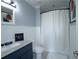 Well lit bathroom with large mirror, and shower with crisp white shower curtain at 2277 Peachtree Ne Rd # 507, Atlanta, GA 30309