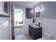 Bathroom with blue vanity, white wainscoting, and view to bright office beyond at 2277 Peachtree Ne Rd # 507, Atlanta, GA 30309