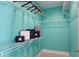 Walk-in closet with white wire shelving and storage with aqua blue paint at 2277 Peachtree Ne Rd # 507, Atlanta, GA 30309