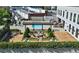 Beautiful courtyard featuring a pool, fireplace, pergola, seating, and green landscaping at 2277 Peachtree Ne Rd # 507, Atlanta, GA 30309