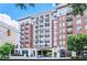 Luxury condo building featuring red brick facade, multiple balconies, and covered entrance in urban setting at 2277 Peachtree Ne Rd # 507, Atlanta, GA 30309
