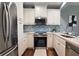 Modern kitchen featuring white cabinets, stainless steel appliances, and stylish backsplash at 2277 Peachtree Ne Rd # 507, Atlanta, GA 30309