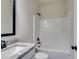 This bathroom features a vanity with a white sink, granite countertops, and a bathtub at 1765 Harmony Rd, Temple, GA 30179