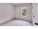 This bedroom features neutral colors, a ceiling fan, and a window with natural light at 1765 Harmony Rd, Temple, GA 30179