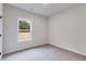 This bedroom features neutral colors, a ceiling fan, and a window with natural light at 1765 Harmony Rd, Temple, GA 30179