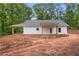 Exterior home elevation features a covered porch and a white siding at 1765 Harmony Rd, Temple, GA 30179