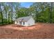 Charming home with board and batten siding surrounded by a lush, wooded landscape on a beautiful lot at 1765 Harmony Rd, Temple, GA 30179