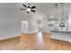 Open-concept living room with wood flooring and modern ceiling fan at 1765 Harmony Rd, Temple, GA 30179
