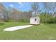 Spacious backyard featuring a storage shed and ample green space, perfect for outdoor activities at 3556 Riley Rd, Douglasville, GA 30134