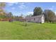 Large grassy backyard with a chain-link fence, offering privacy and space for outdoor activities at 3556 Riley Rd, Douglasville, GA 30134