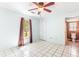 Bedroom with light blue walls, tile floor, ceiling fan, and an ensuite bathroom at 3556 Riley Rd, Douglasville, GA 30134