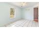 Light blue bedroom with tile floor, window, and light fixture at 3556 Riley Rd, Douglasville, GA 30134