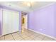 Bedroom with tile flooring, neutral walls, and a closet at 3556 Riley Rd, Douglasville, GA 30134