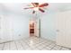 Bedroom featuring tiled floors, ceiling fan, and white doors at 3556 Riley Rd, Douglasville, GA 30134