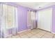 Bedroom featuring tile flooring, large window with decorative curtains, and built-in closet at 3556 Riley Rd, Douglasville, GA 30134