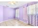 Bright bedroom with tile flooring, purple walls and large, sheer curtains at 3556 Riley Rd, Douglasville, GA 30134