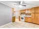 Well-lit kitchen features tiled floors, a mosaic backsplash, and ample wooden cabinets at 3556 Riley Rd, Douglasville, GA 30134