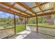 Covered backyard patio area with wooden deck, views and fenced-in yard at 3556 Riley Rd, Douglasville, GA 30134