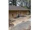 Side view of a detached garage with multiple doors, showing peeling paint and general disrepair at 4216 Connor Dr, Ellenwood, GA 30294