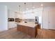 Modern kitchen with stainless steel appliances, a large island, and stylish white cabinets at 675 Drewry Ne St # 303, Atlanta, GA 30306