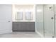 Modern bathroom with double sink vanity, framed mirrors, and glass shower enclosure with white subway tiles at 134 Wards Crossing Way # 17, Johns Creek, GA 30022