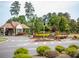 Community entrance with manicured landscaping, shrubbery, and a clear view of the community signage at 134 Wards Crossing Way # 17, Johns Creek, GA 30022