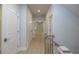 Upstairs hallway featuring multiple doors, wood flooring, and natural light, connecting the living spaces at 134 Wards Crossing Way # 17, Johns Creek, GA 30022