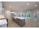 Kitchen with white cabinets, stainless appliances, large island with sink, and a sliding glass door at 134 Wards Crossing Way # 17, Johns Creek, GA 30022