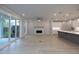 Open-concept living space with fireplace, sliding glass doors to patio, and a kitchen area at 134 Wards Crossing Way # 17, Johns Creek, GA 30022