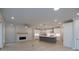 Open-concept living area with modern fireplace and kitchen island, great for entertaining and Gathering gatherings at 134 Wards Crossing Way # 17, Johns Creek, GA 30022