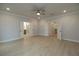 Large main bedroom featuring light-colored walls, light wood floors, and a ceiling fan with attached bath and walk-in closet at 134 Wards Crossing Way # 17, Johns Creek, GA 30022