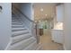 Staircase leading to open living space with backyard view, enhancing natural light and interior flow at 134 Wards Crossing Way # 17, Johns Creek, GA 30022