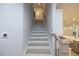 Bright staircase with wooden handrail, offering a seamless transition between floors in the home at 134 Wards Crossing Way # 17, Johns Creek, GA 30022