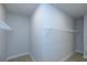 A corner view of a walk-in closet with white wire shelving and light wood floors at 134 Wards Crossing Way # 17, Johns Creek, GA 30022