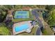 Aerial view of the community amenities including a pool, tennis courts, playground, and parking at 169 Twickenham Trce, Suwanee, GA 30024
