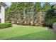 Lush green backyard, with manicured lawn and landscaping, provides a serene outdoor setting at 169 Twickenham Trce, Suwanee, GA 30024
